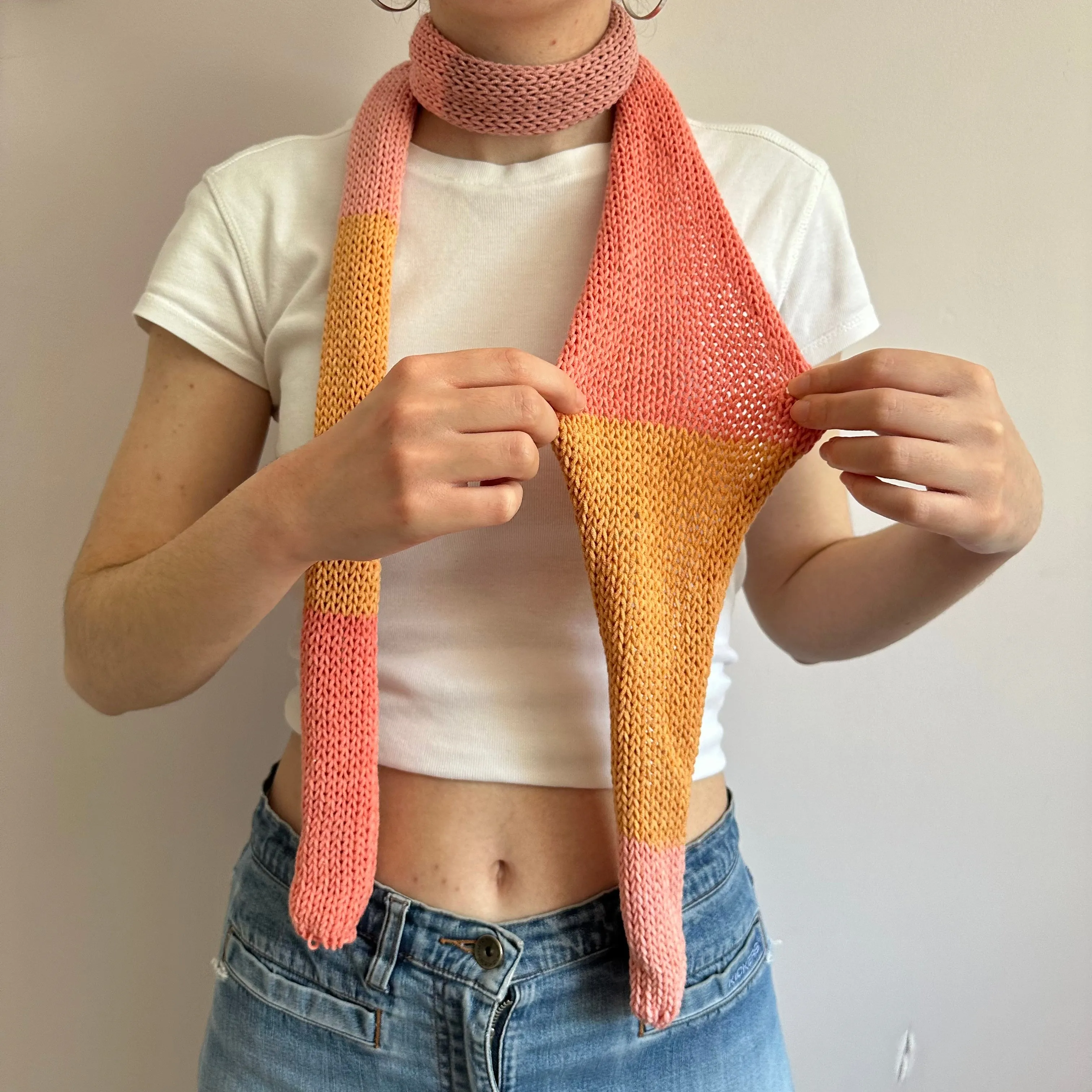 Handmade knitted colour block skinny scarf in coral and orange