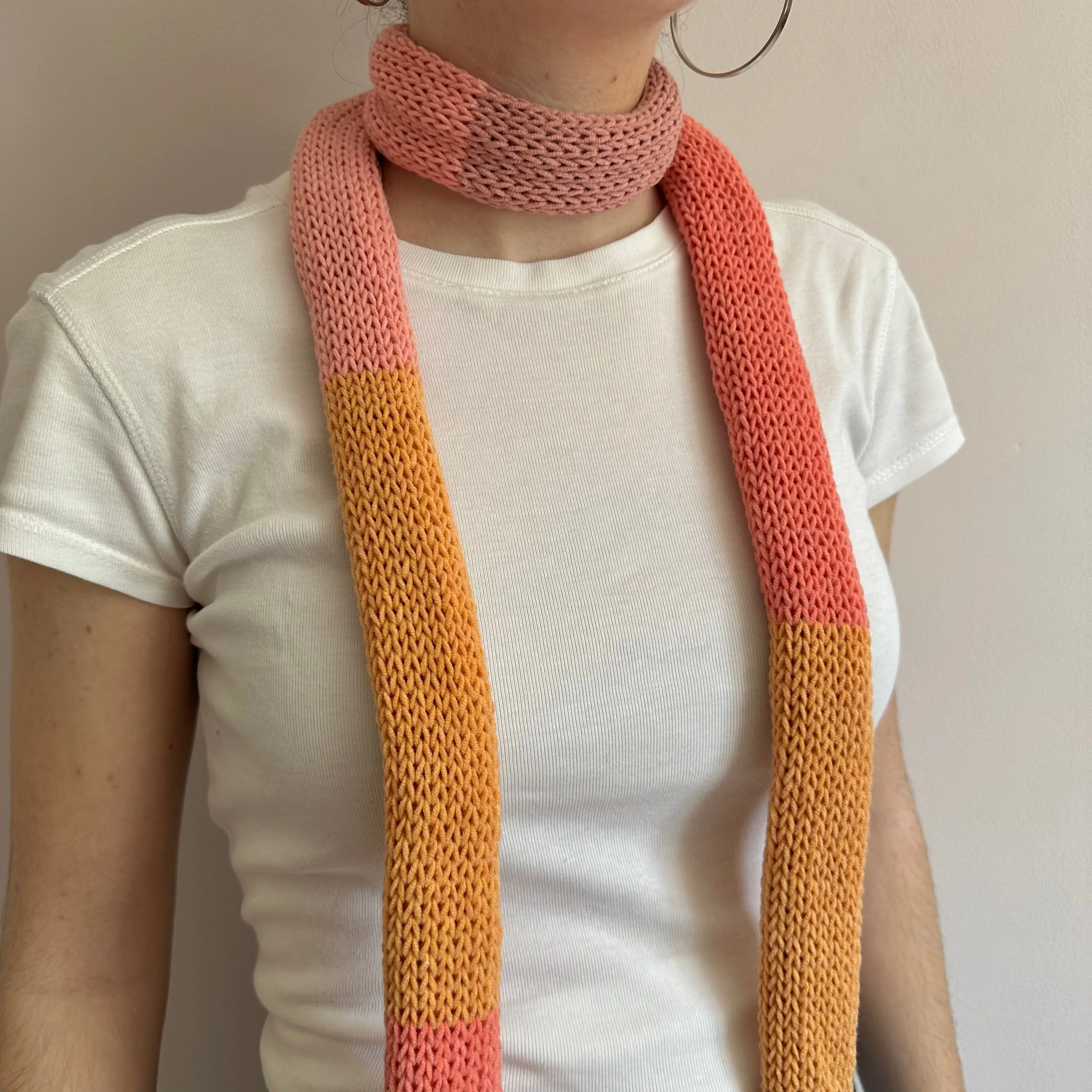 Handmade knitted colour block skinny scarf in coral and orange